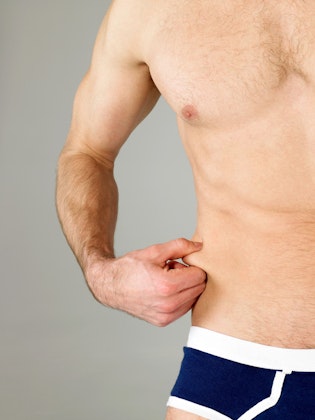 Man holding stubborn side fat