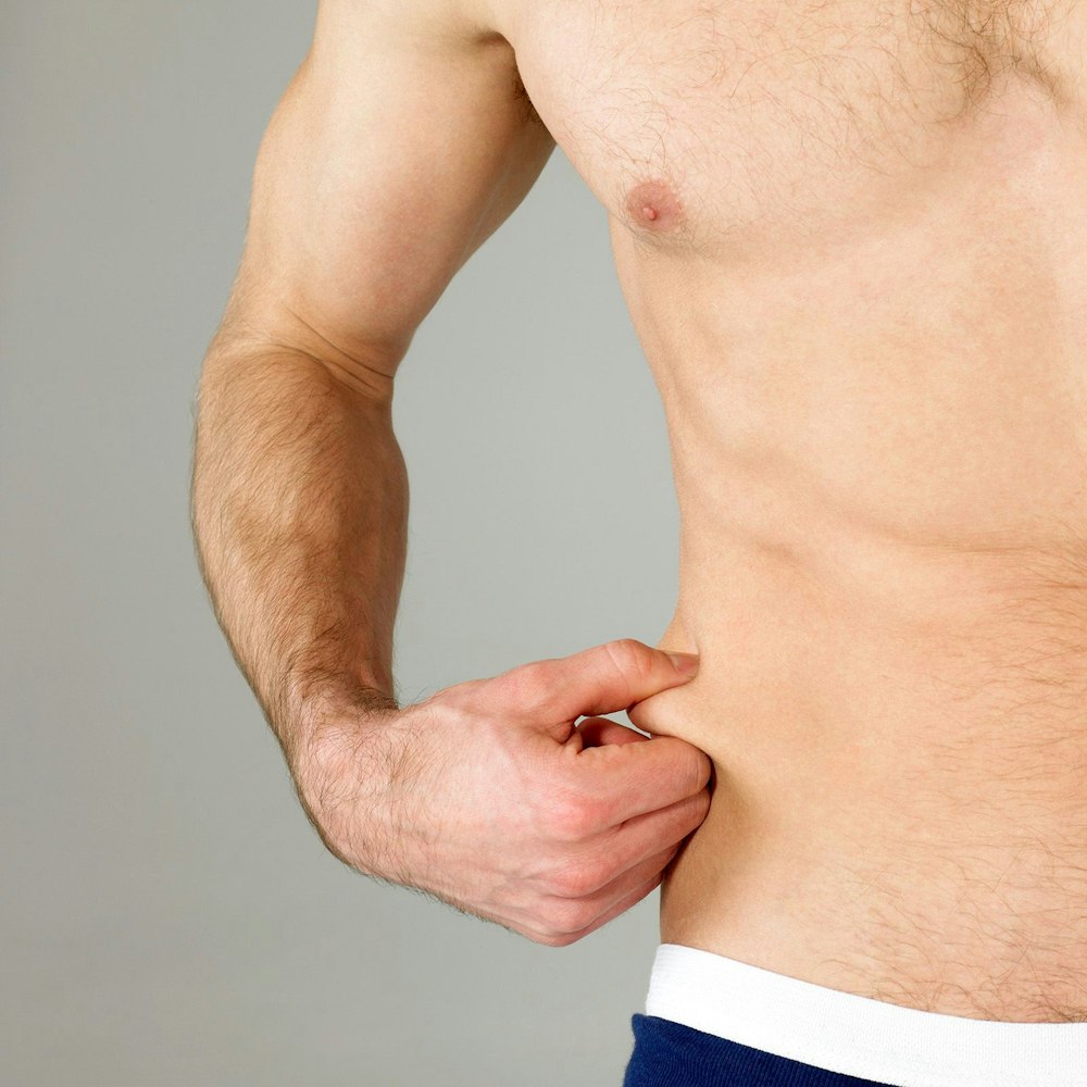 Man holding saggy skin