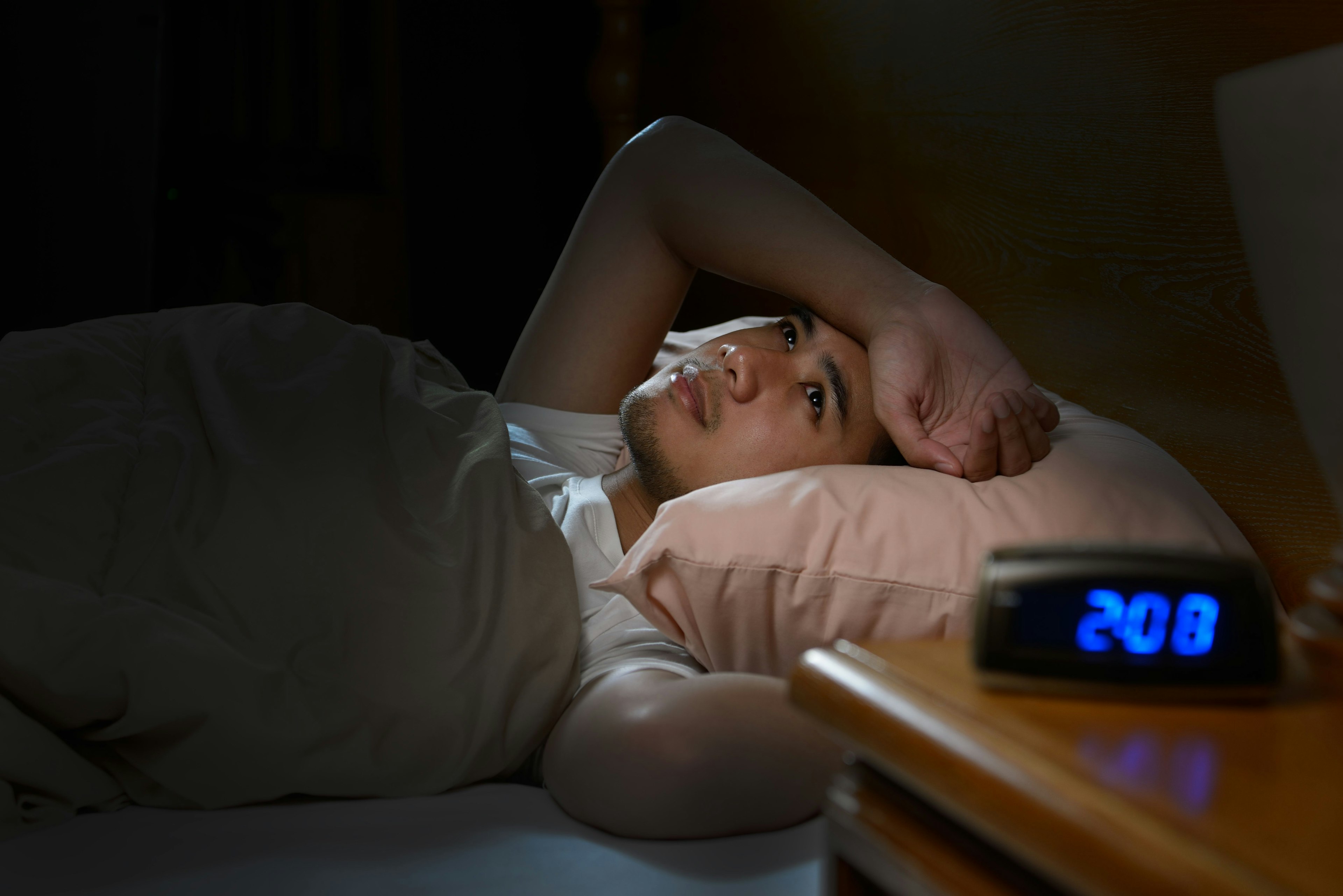 Man lying awake in bed