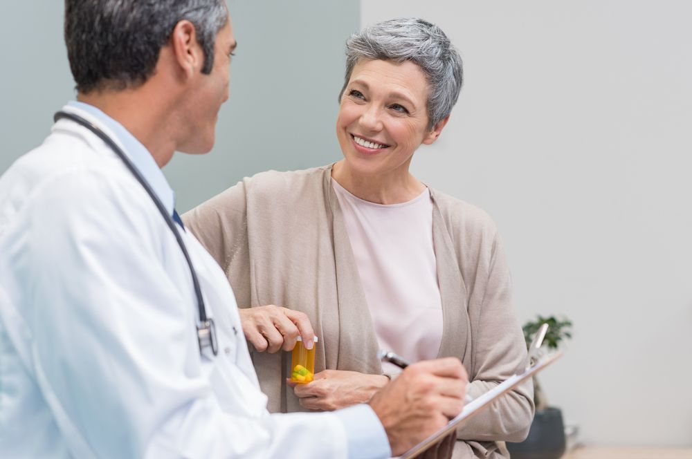 Older woman talking with a doctor about menopause medication