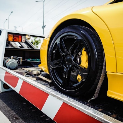 yellow car being towed