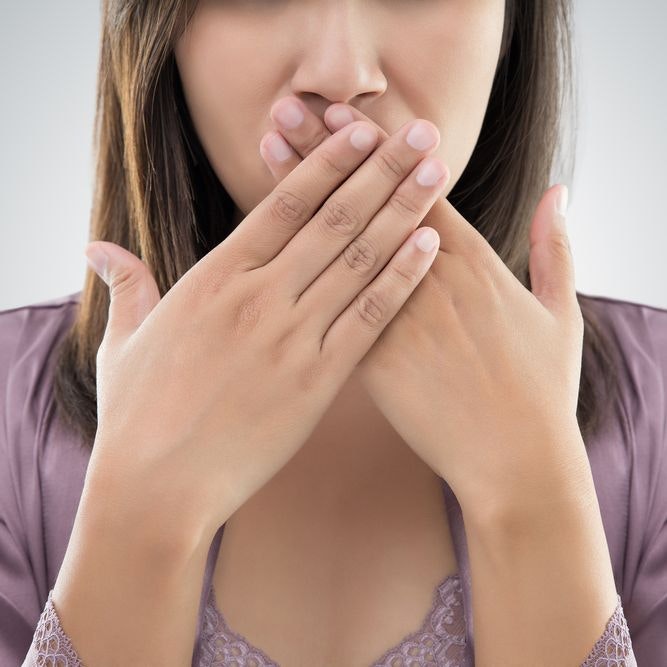 Woman covering her mouth