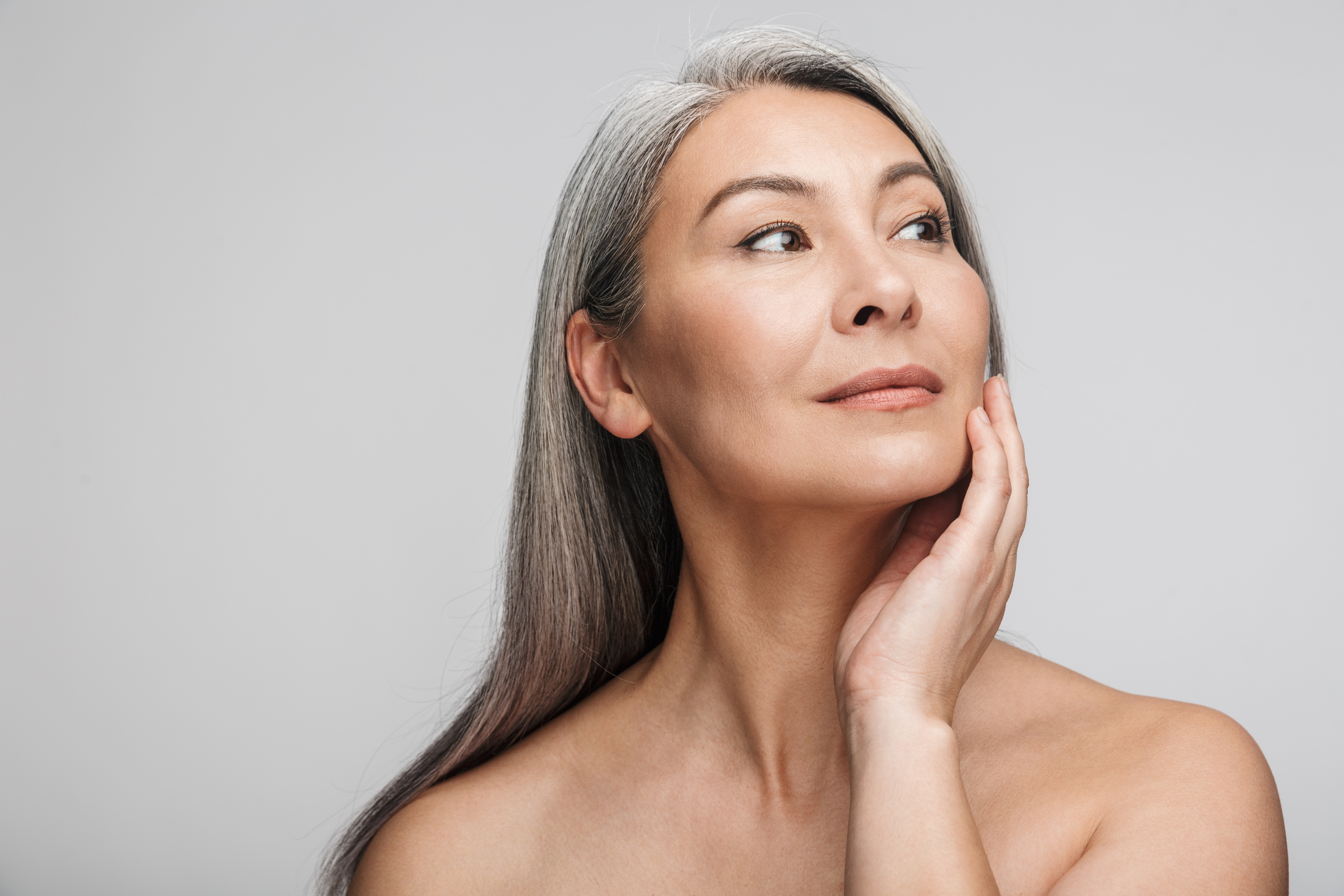 Mature woman touching cheeks