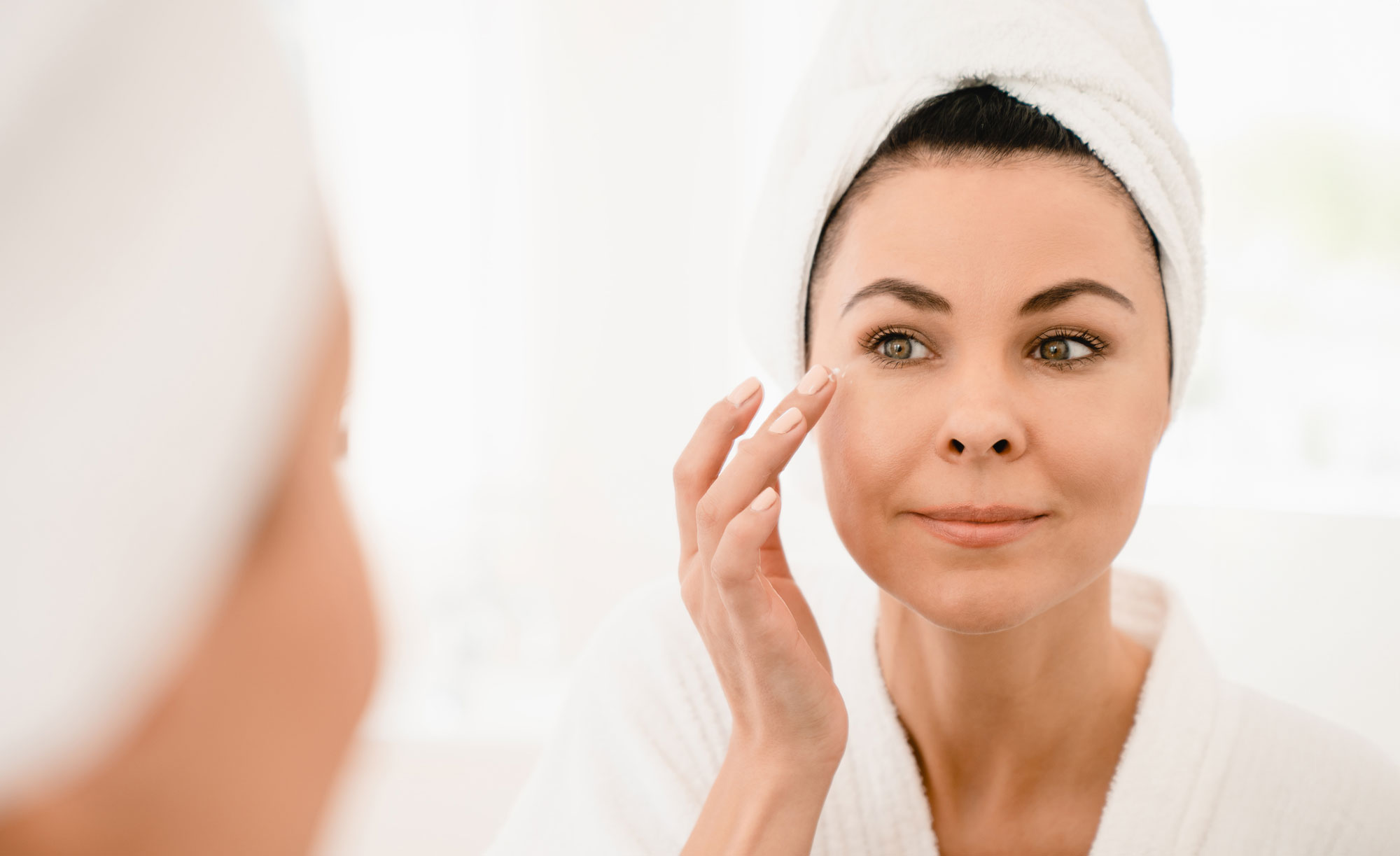woman applying eye cream