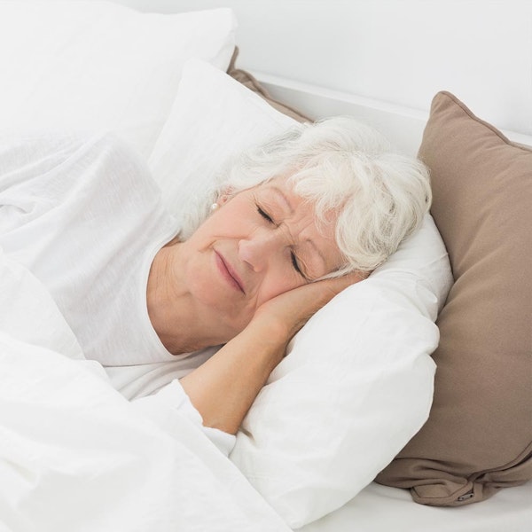 Mature woman sleeping in bed