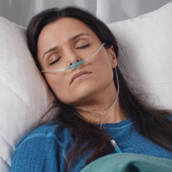 Woman sleeping with at-home sleep study kit