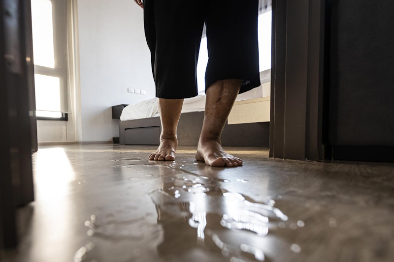 Older person walking out of room where the floor is wet