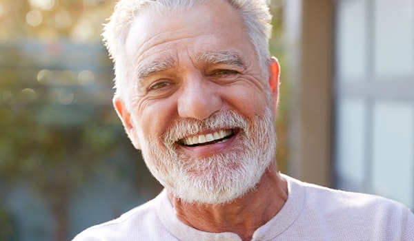 smiling mature man wearing dentures