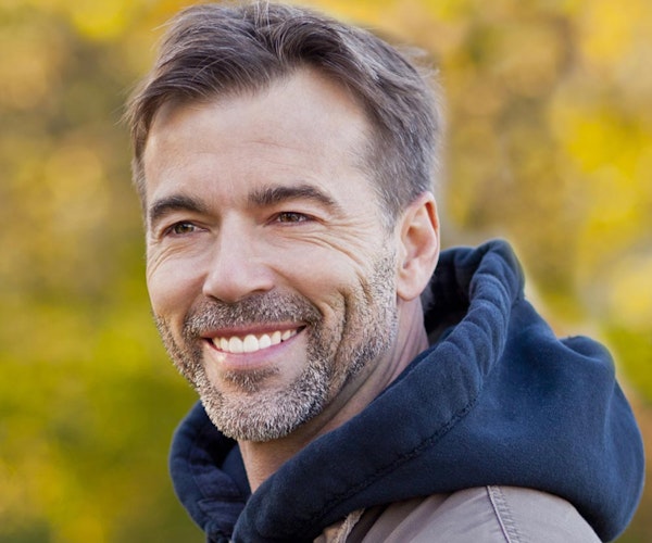 Older man smiling with dental bridge