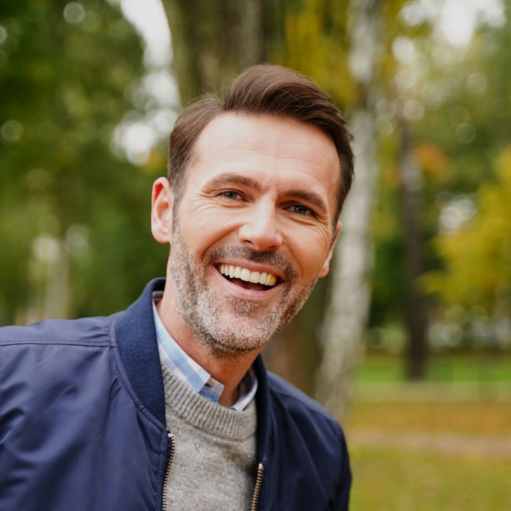 Smiling man in a park