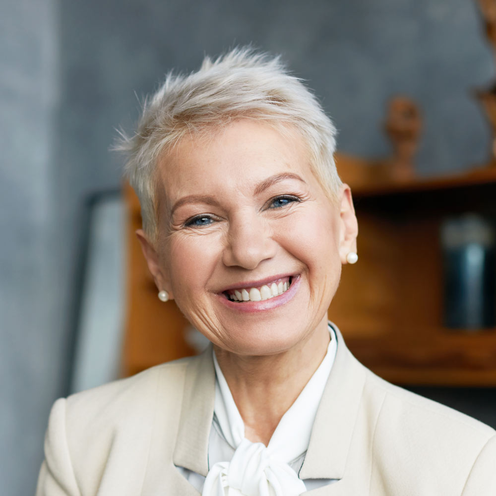 Smiling mature woman after restorative dentistry treatments