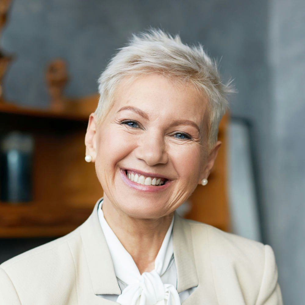 Smiling mature woman with dental implants