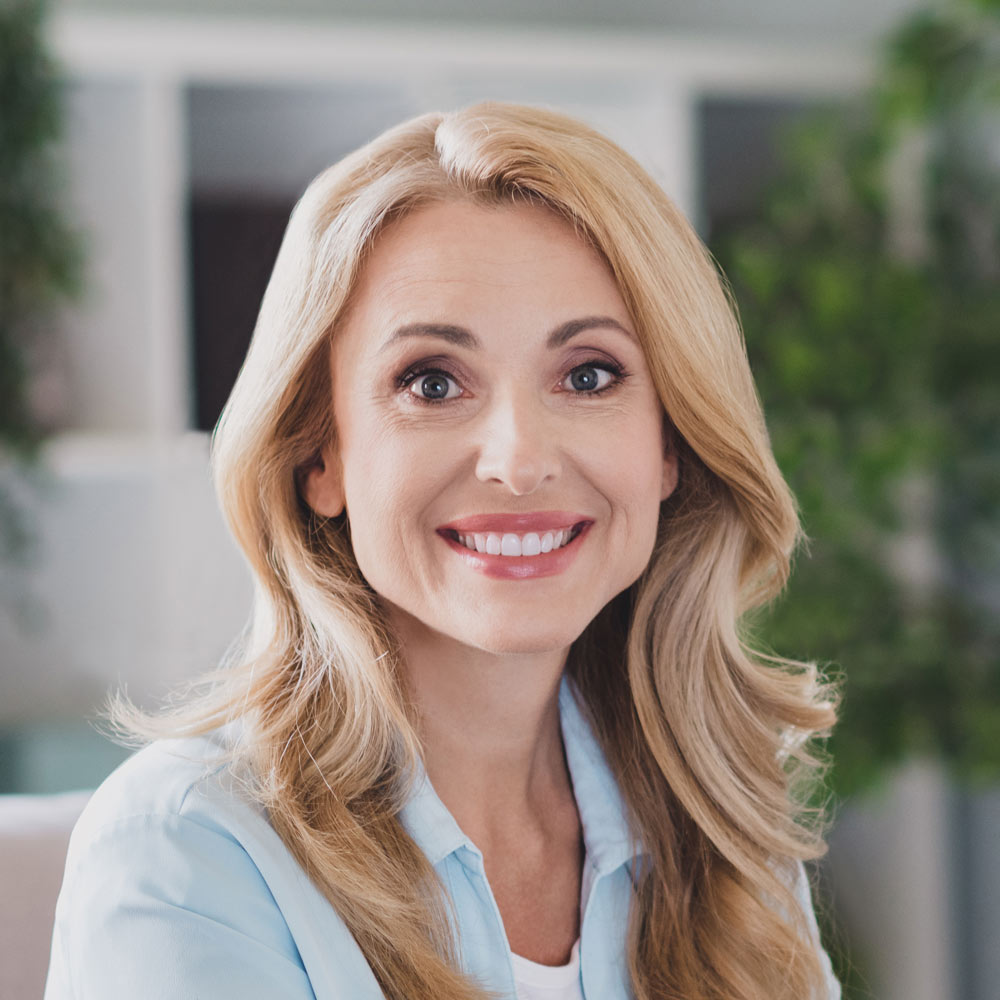 Smiling mature woman with curly blonde hair
