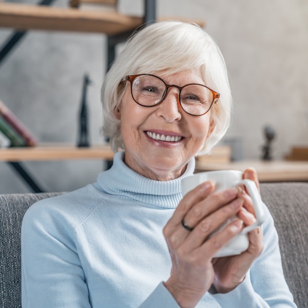 Mature woman holding a mug while smiling