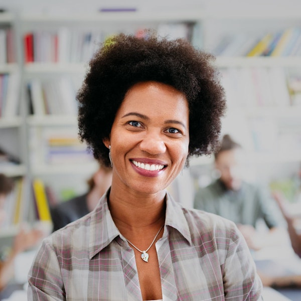 Smiling mature woman at work after a tooth extraction