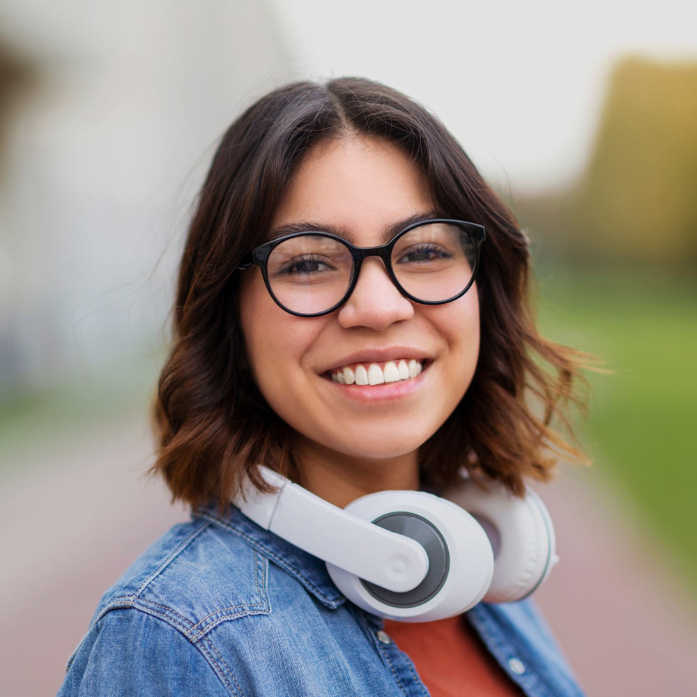 smiling woman with headphones and teeth whitening