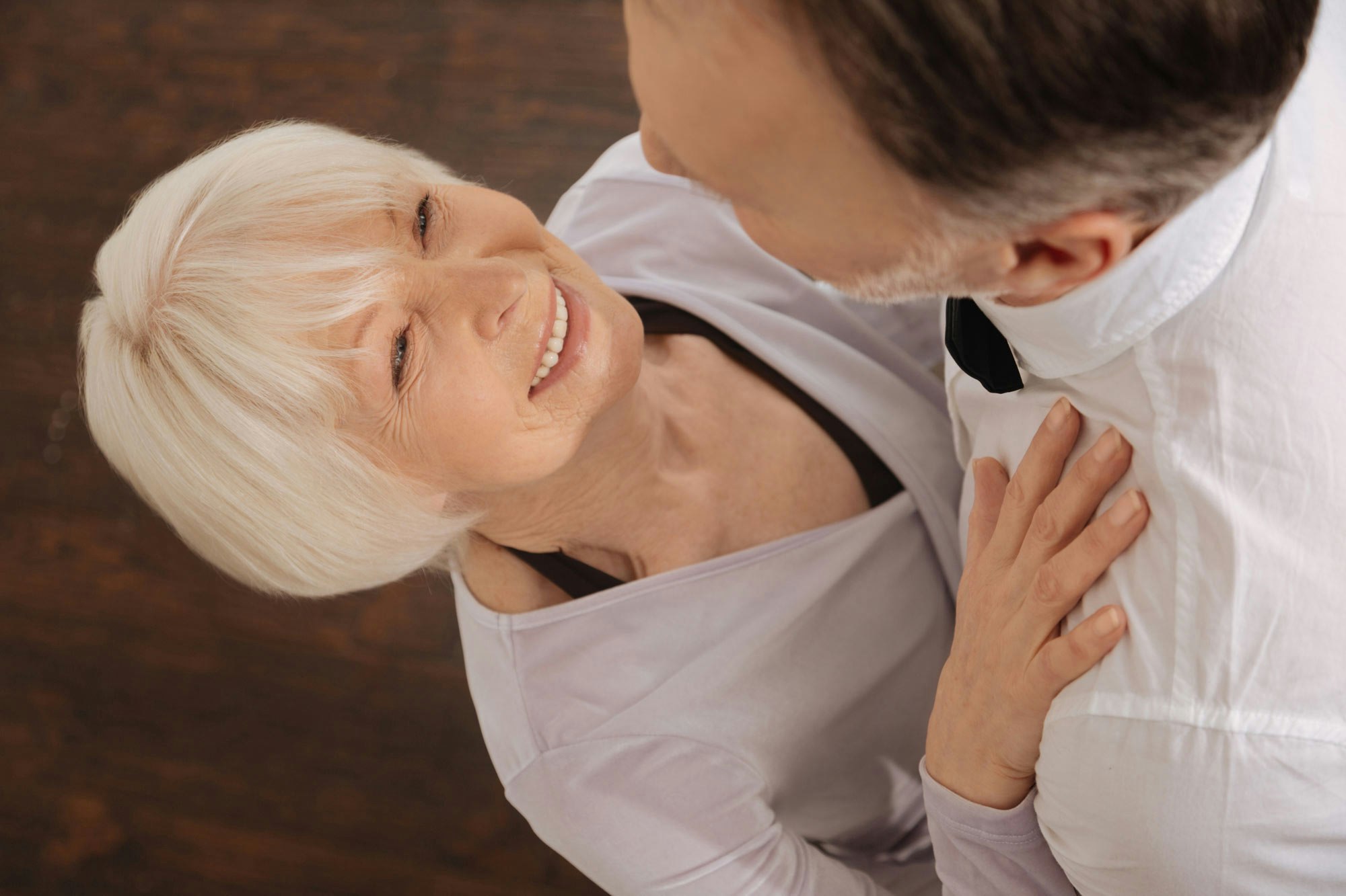 Smiling mature woman dancing with a man