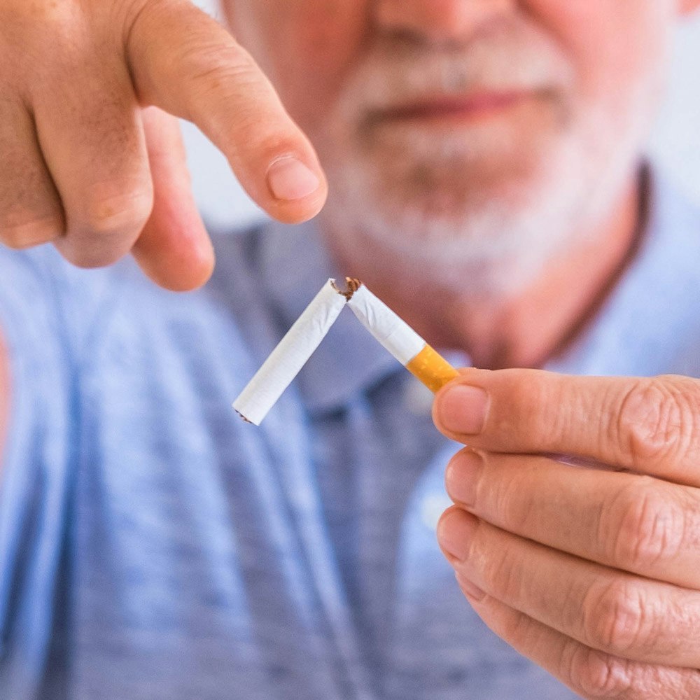 Man pointing at a broken cigarette