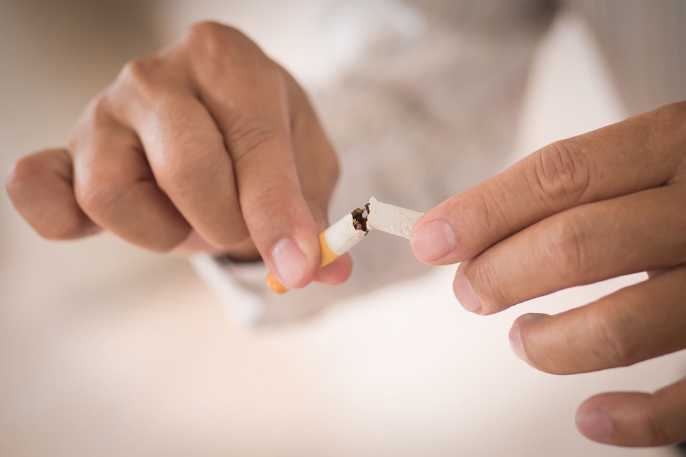 Man breaking cigarette
