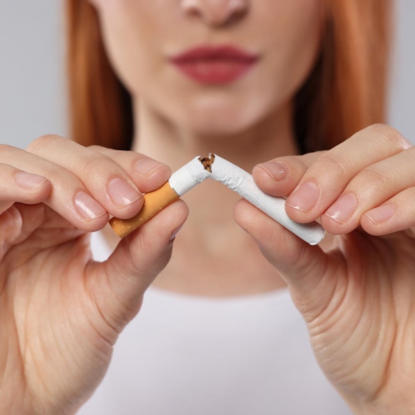 Close up of a woman breaking a cigarette