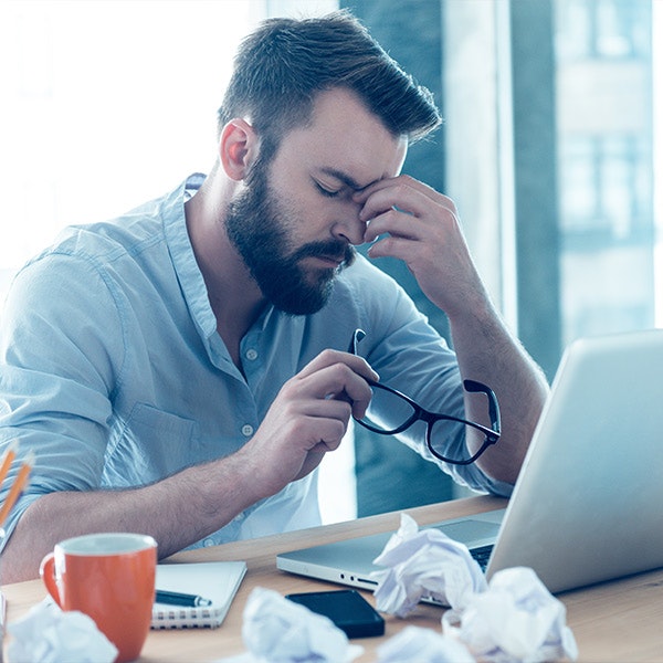 Man rubbing his eyes in discomfort