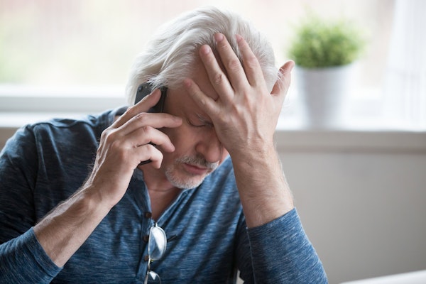 Stressed man after scam call