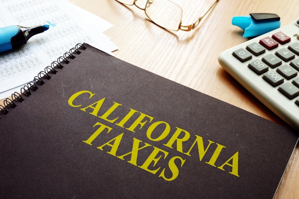 California Taxes Notebook, glasses, and calculator