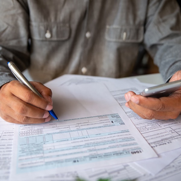 Man calculating federal income taxes