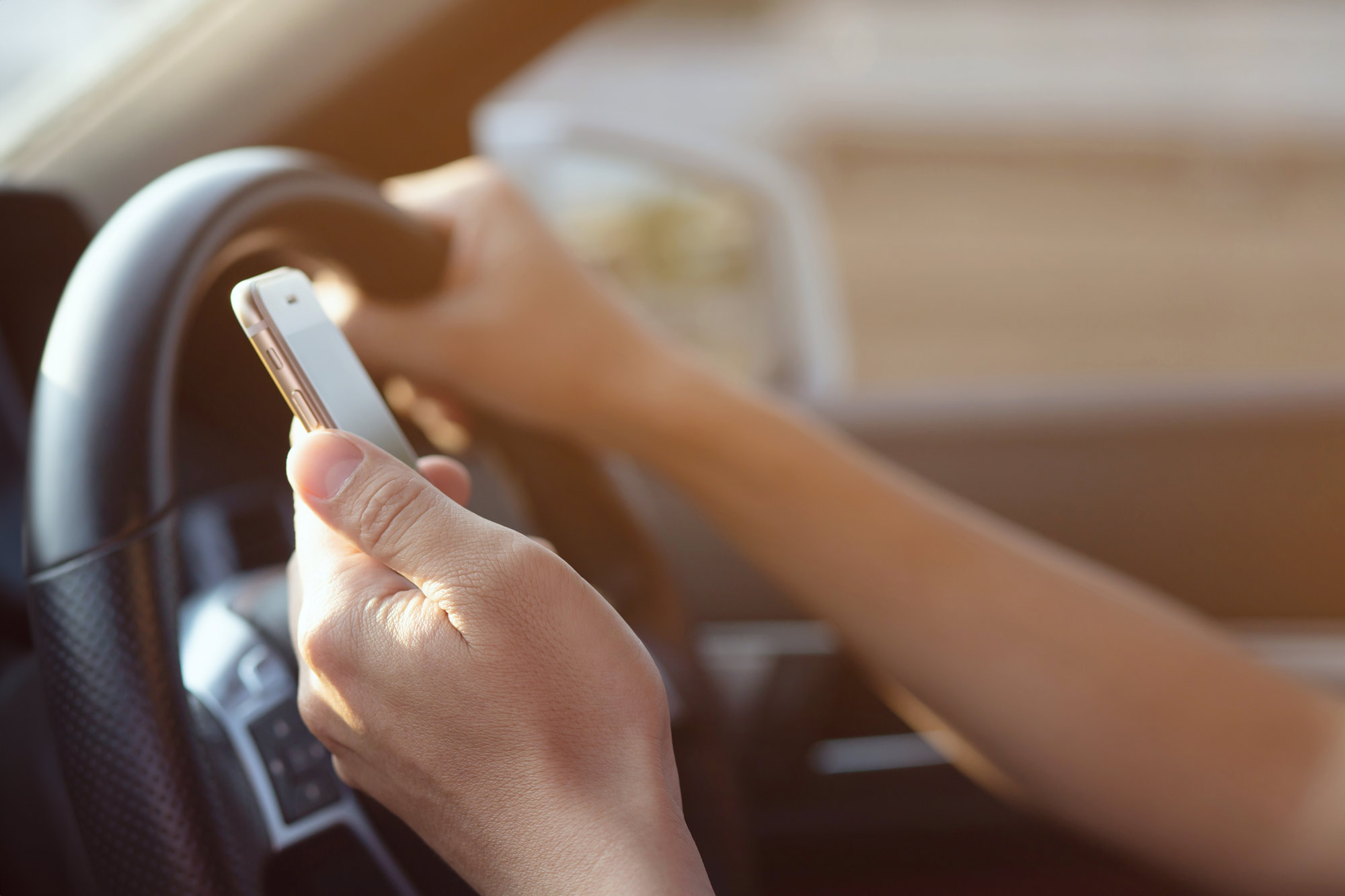 Person driving while looking at phone