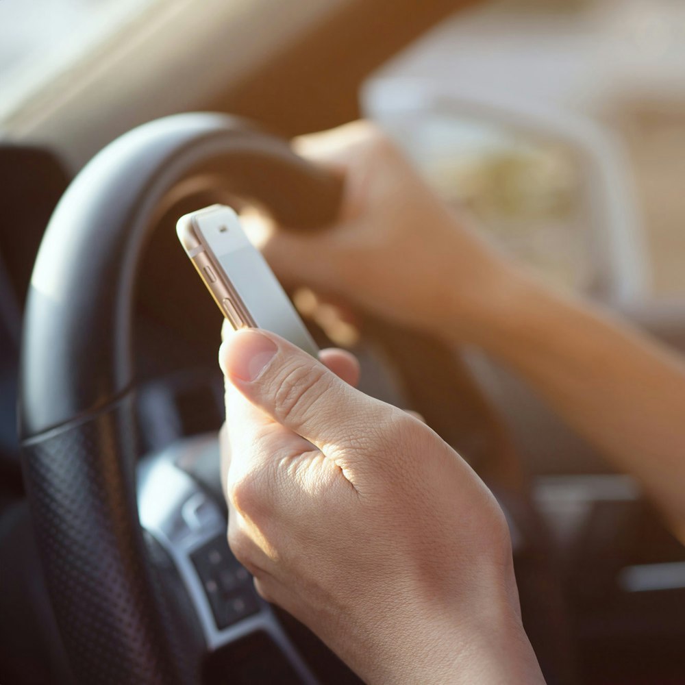 Person driving while looking at phone