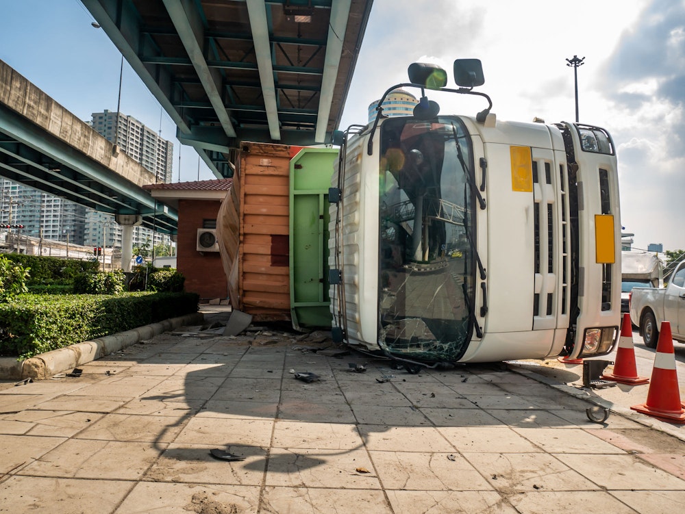 Truck on its side in the city