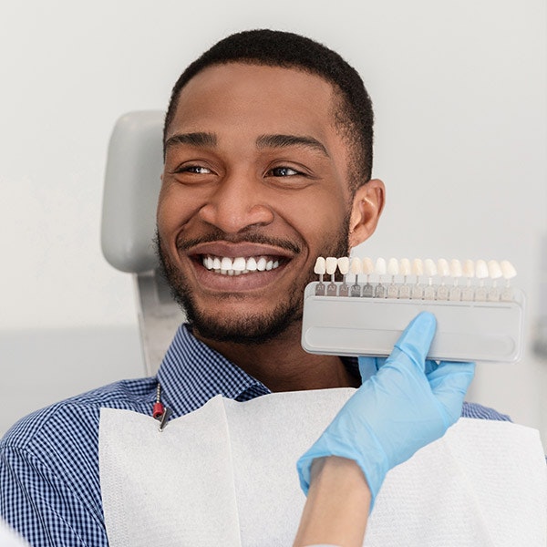 Man comparing Veneers shades