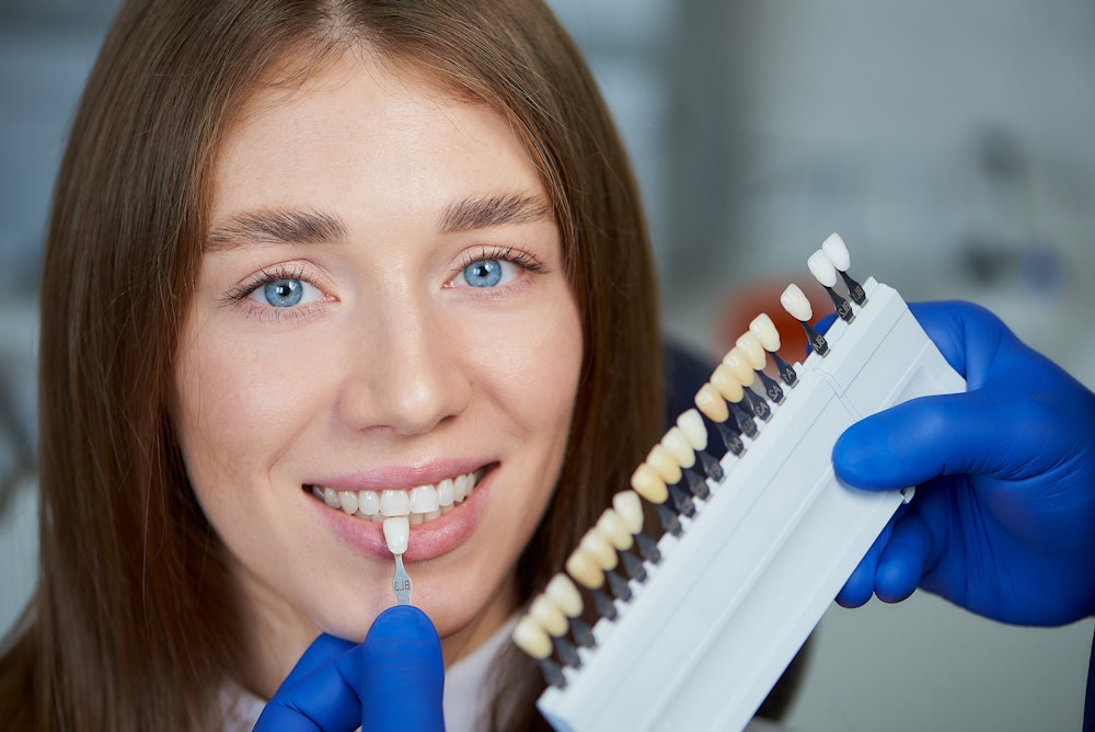 Woman comparing Porcelain veneers