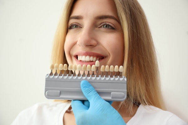 Woman comparing different shades of veneers