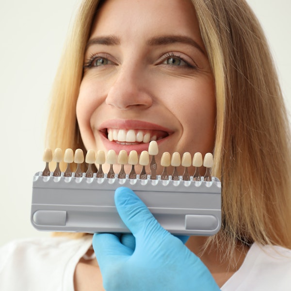 Woman comparing different shades of veneers
