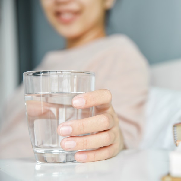 Woman holding a glass of water