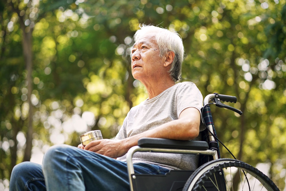 Sad mature man in wheelchair
