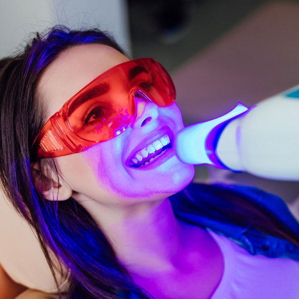 woman whitening teeth
