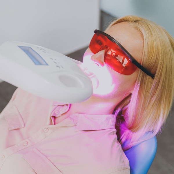 Woman receiving teeth whitening