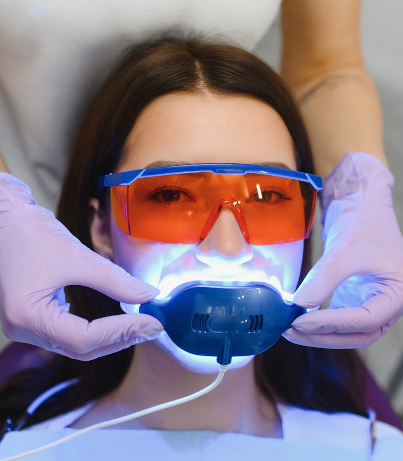 Woman getting in-office teeth whitening procedure