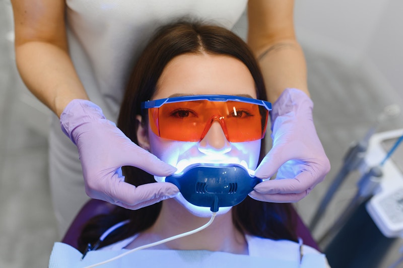 Woman getting in-office teeth whitening procedure