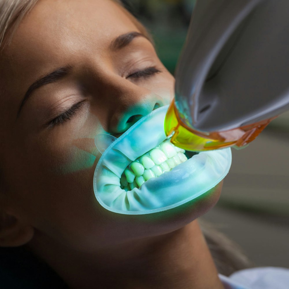 Woman undergoing professional whitening treatment