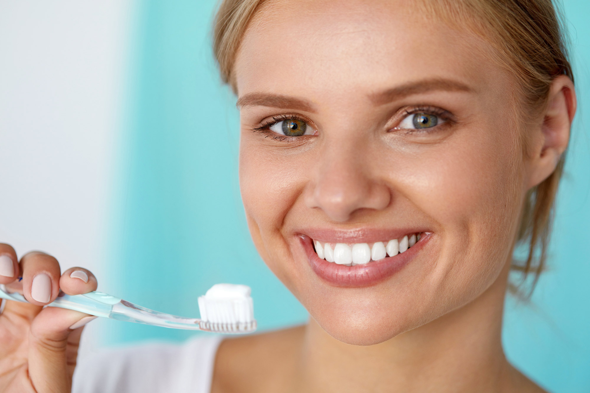 Smiling woman holding a toothbrush