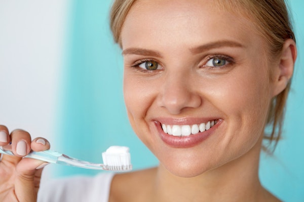 Woman with Teeth Whitening and toothbrush