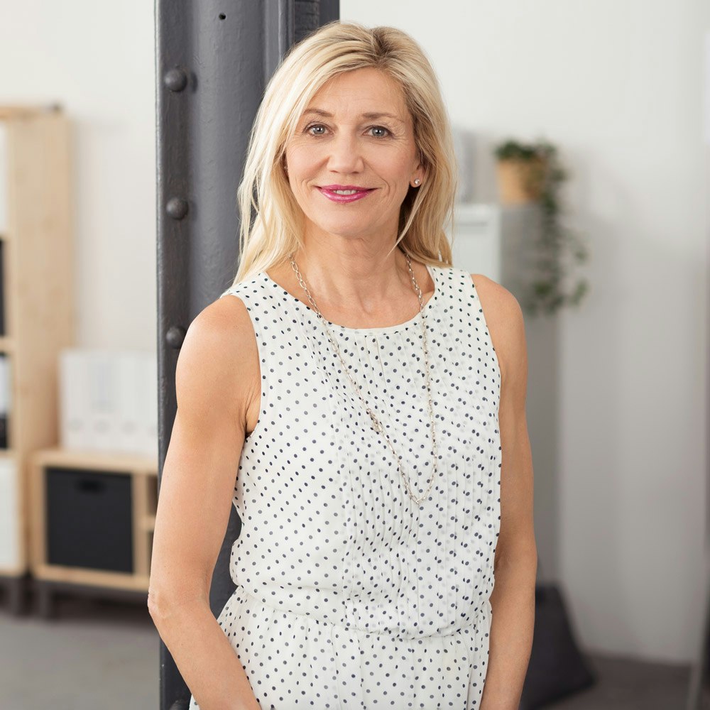 Mature business woman smiling after resolving an FMLA dispute