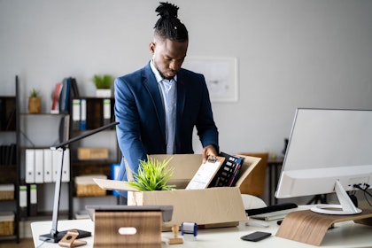 man packing up his belongings at work